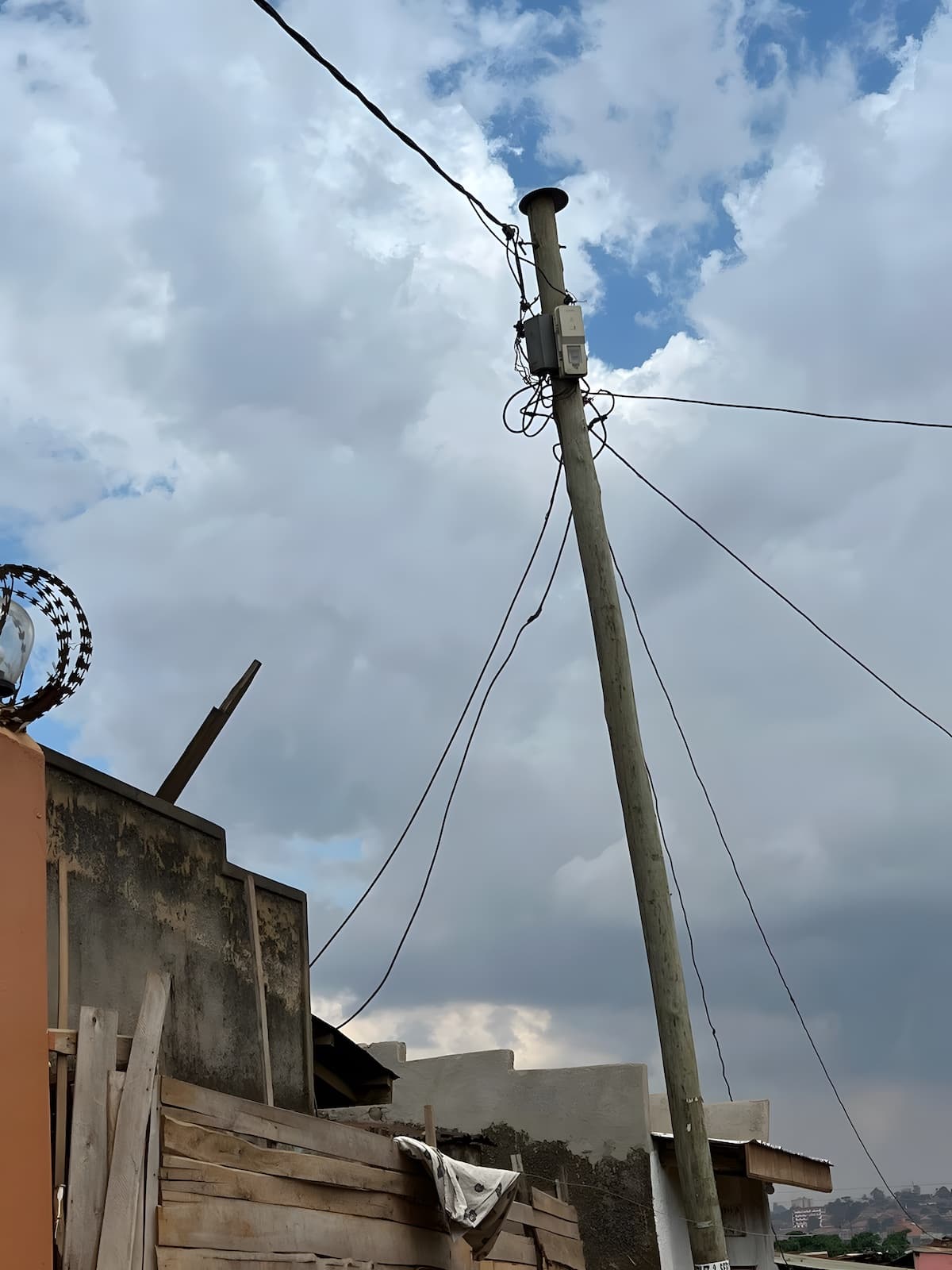 A utility pole with prepaid meters (white boxes) (credit: Paul Kyoma)